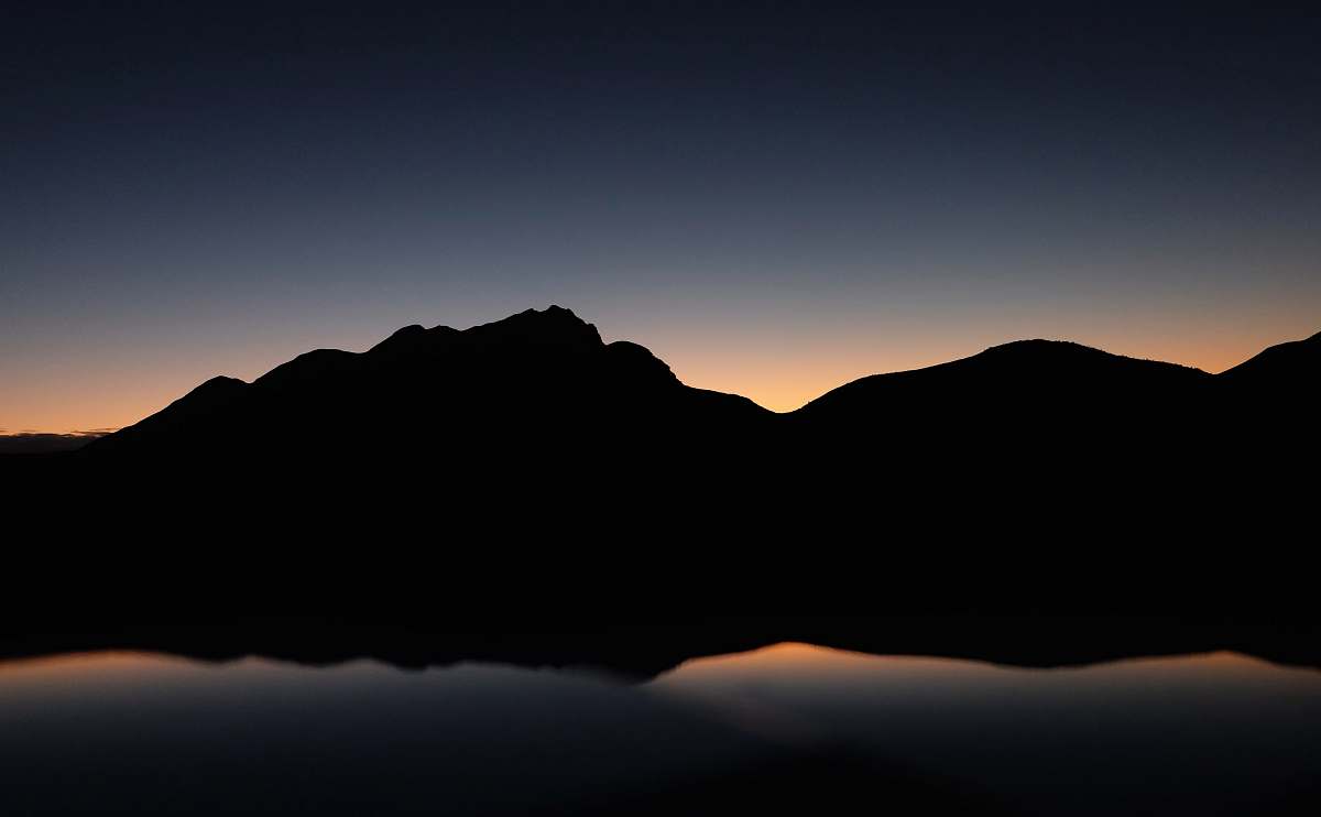 desktop wallpapers silhouette photography of mountain near body of water desktop backgrounds